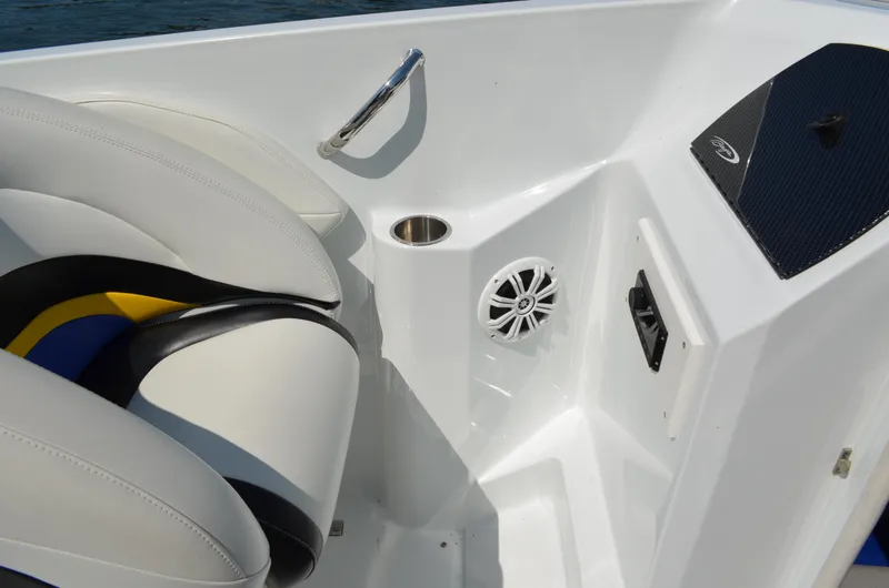 Slide: The Image of 2008 Baja 26 Outlaw boat interior with white seating, speaker, and cup holder. - 23