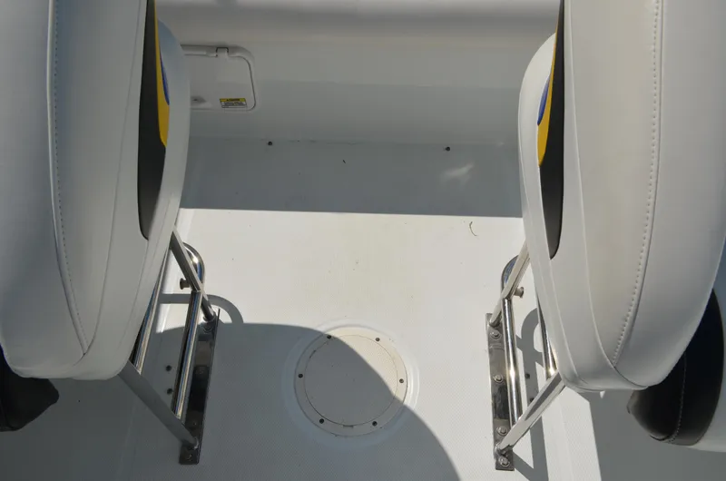 Slide: The Image of 2008 Baja 26 Outlaw boat interior with white seating and metal supports. - 25