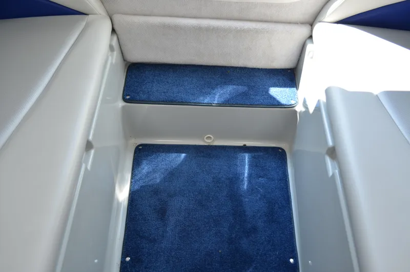 Slide: The Image of 2008 Baja 26 Outlaw interior with blue carpet and white seating. - 31