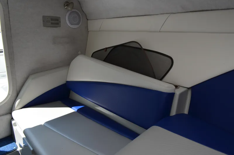 Slide: The Image of Interior of 2008 Baja 26 Outlaw boat with blue and white seating. - 32