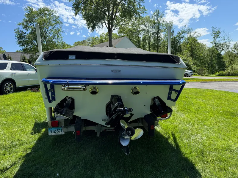 Slide: The Image of 2008 Baja 26 Outlaw boat rear view on grass, sunny day, trees in background. - 38