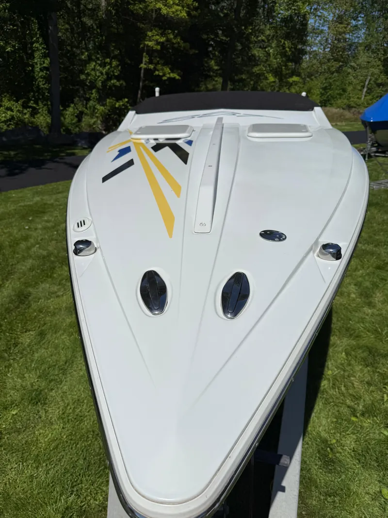 Slide: The Image of 2008 Baja 26 Outlaw boat with sleek design on grassy area. - 39
