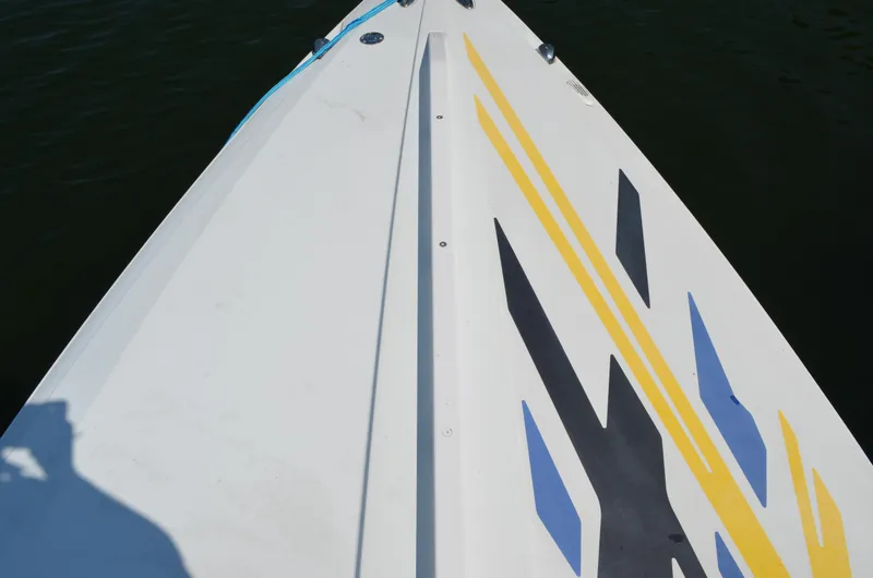 Slide: The Image of 2008 Baja 26 Outlaw boat deck with colorful graphics on calm water. - 7