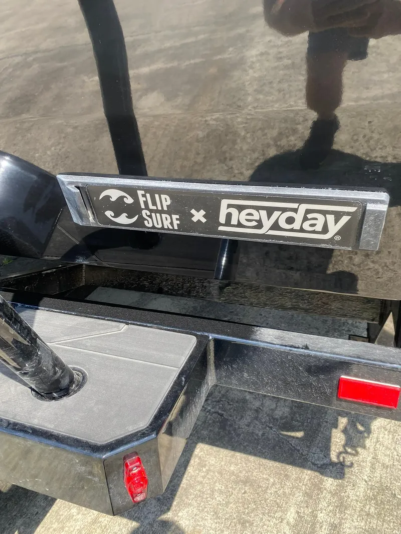 Slide: The Image of Heyday WT-2DC 2025 boat with Flip Surf branding on black surface. - 10