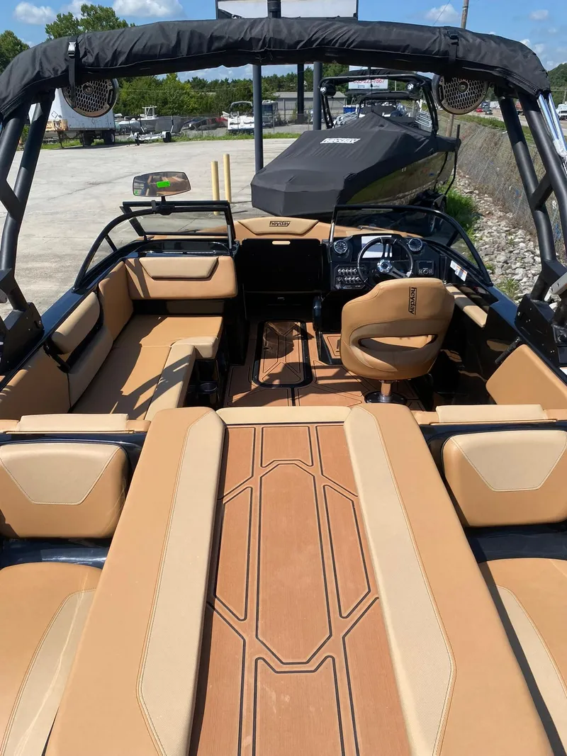 Slide: The Image of 2025 Heyday WT-2DC boat interior with tan seating and modern dashboard. - 11
