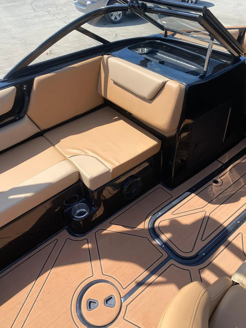 Slide: The Image of 2025 Heyday WT-2DC boat interior with tan seating and sleek black accents. - 13