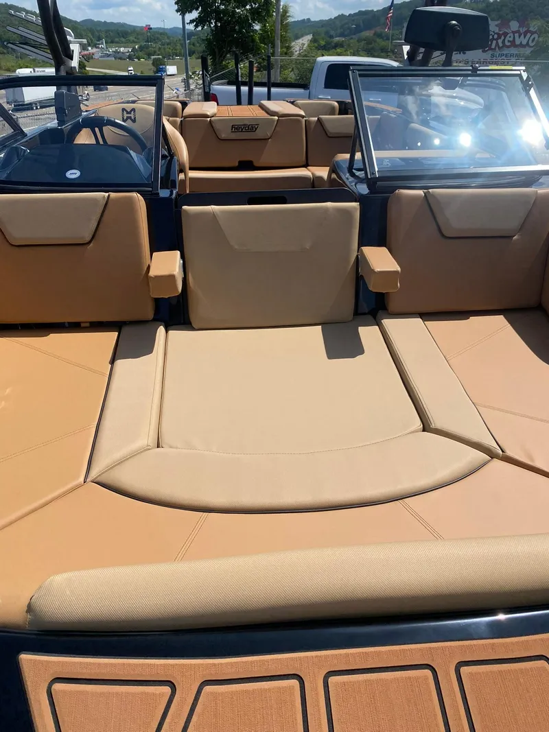 Slide: The Image of 2025 Heyday WT-2DC boat interior with tan seating and open deck design. - 9