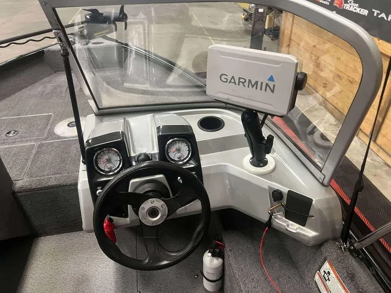 Slide: The Image of 2016 Tracker Pro Guide V-16 WT boat dashboard with Garmin GPS and steering wheel. - 4