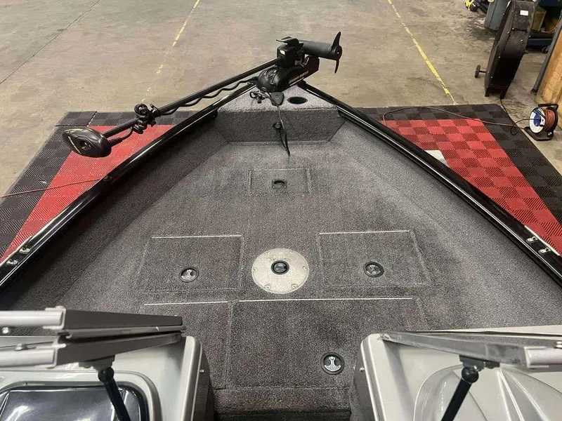 Slide: The Image of 2016 Tracker Pro Guide V-16 WT boat interior with trolling motor and storage compartments. - 5