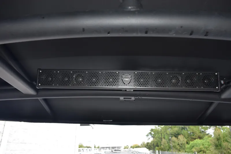 Slide: The Image of 2023 Yamaha Boats 255XD sound system detail under canopy. - 10