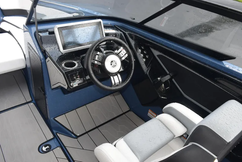Slide: The Image of 2023 Yamaha Boats 255XD cockpit with steering wheel, touchscreen, and modern controls. - 11