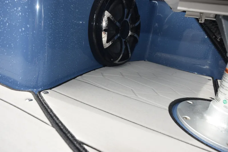 Slide: The Image of 2023 Yamaha Boats 255XD interior with speaker and wet deck flooring. - 15