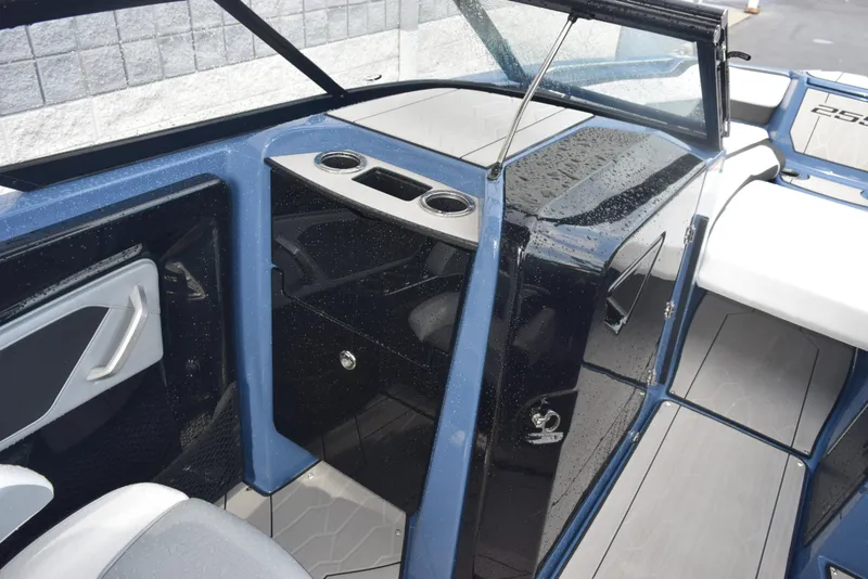 Slide: The Image of 2023 Yamaha Boats 255XD interior with sleek design and cup holders. - 16