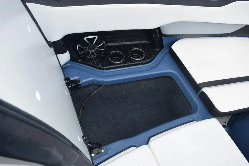 Slide: The Image of 2023 Yamaha Boats 255XD interior with white seating, speaker, and cup holders. - 20