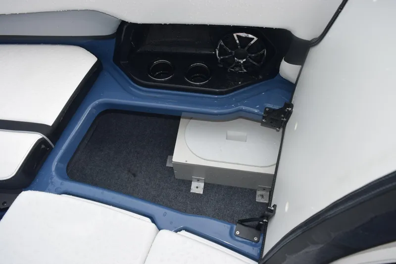 Slide: The Image of 2023 Yamaha Boats 255XD interior storage compartment with speaker and cup holders. - 21