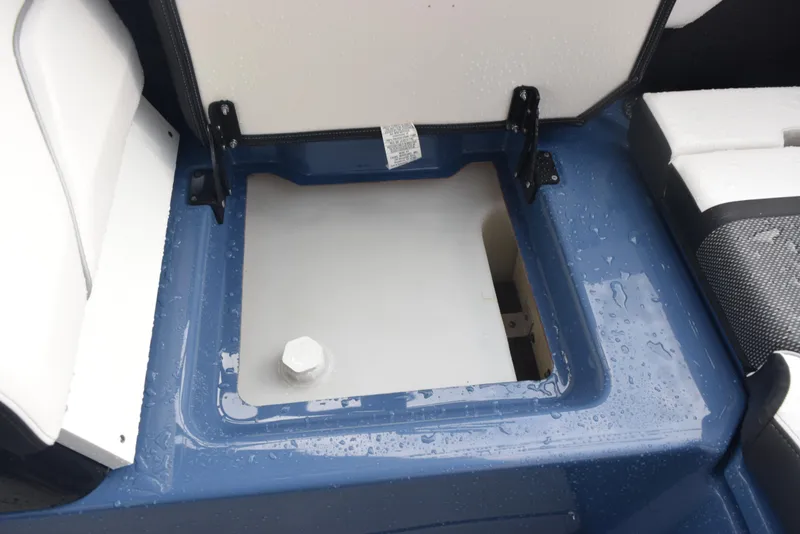 Slide: The Image of 2023 Yamaha Boats 255XD storage compartment with open lid, showcasing interior details. - 27
