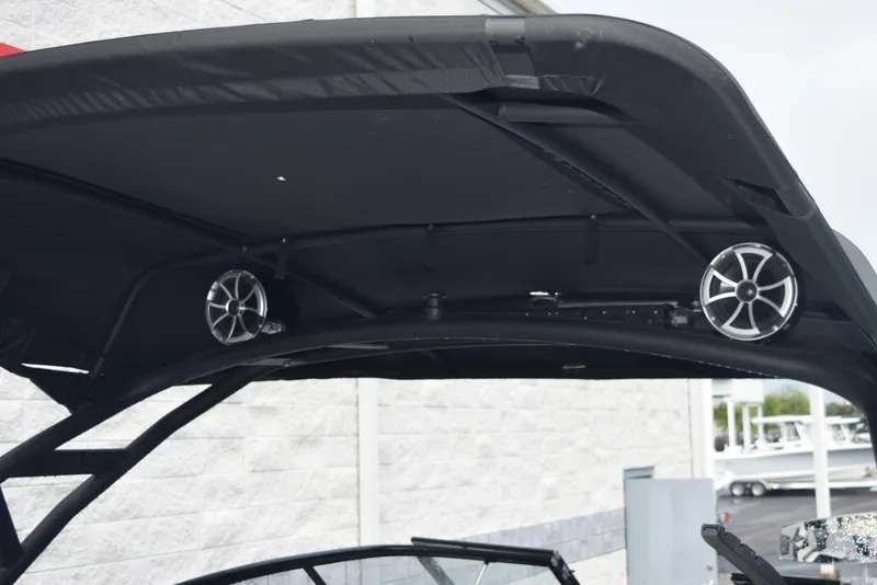 Slide: The Image of 2023 Yamaha Boats 255XD with speakers on black canopy, outdoor setting. - 9