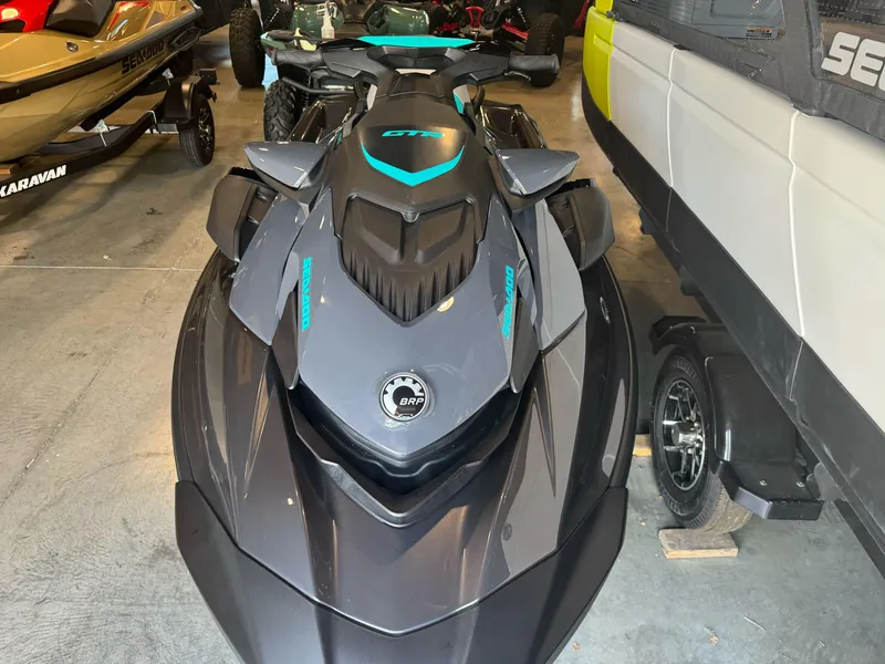 Slide: The Image of 2025 Sea-Doo GTR 230 jet ski in a showroom, showcasing sleek design and modern features. - 2
