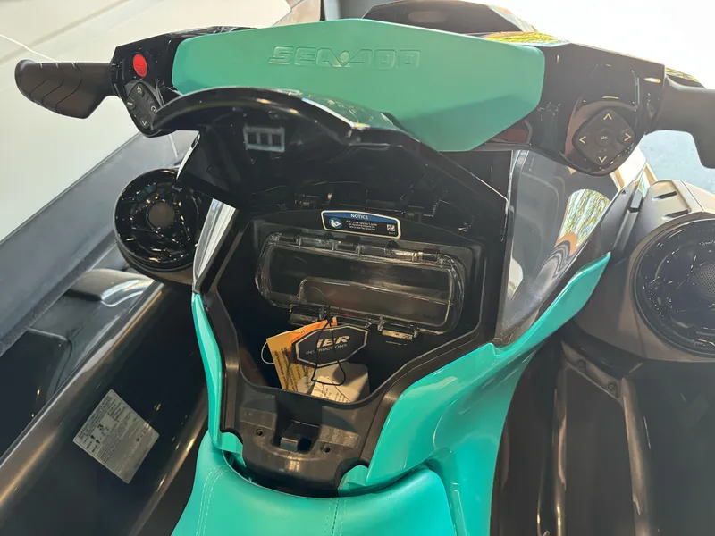 Slide: The Image of 2025 Sea-Doo GTR 230 dashboard with storage compartment open, showcasing controls and design. - 9