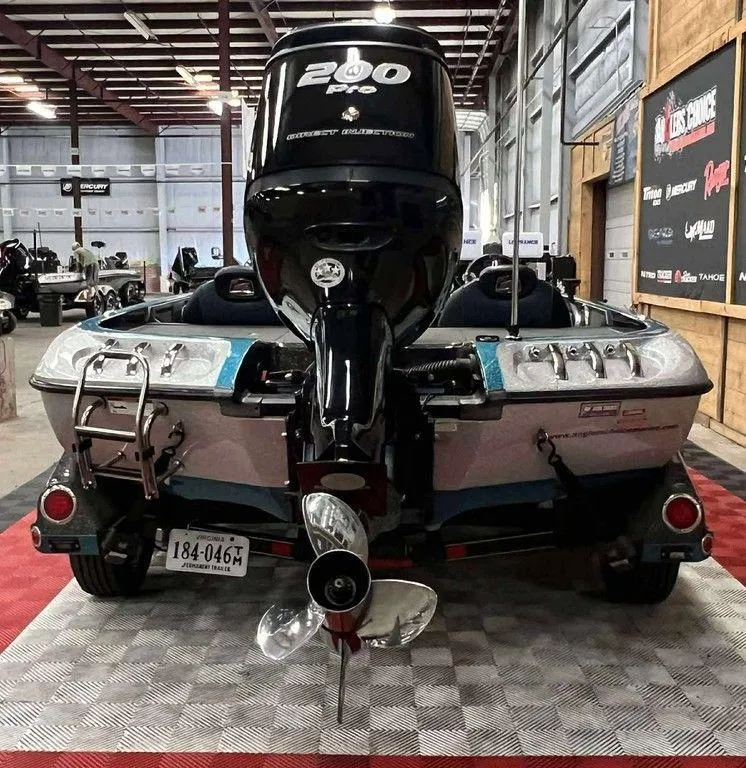 Slide: The Image of 2016 Ranger Z518c boat with 200 HP motor displayed indoors. - 5