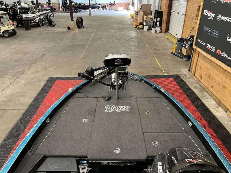 Slide: The Image of 2016 Ranger Z518c bass boat in a garage, showcasing deck and equipment. - 6