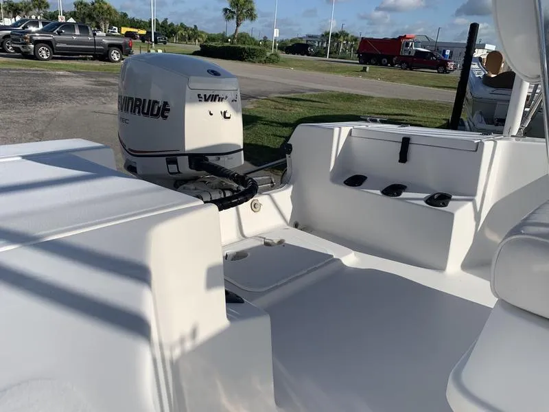 Slide: The Image of 2008 Sea King 180 CC boat with Evinrude outboard motor, parked outdoors. - 10