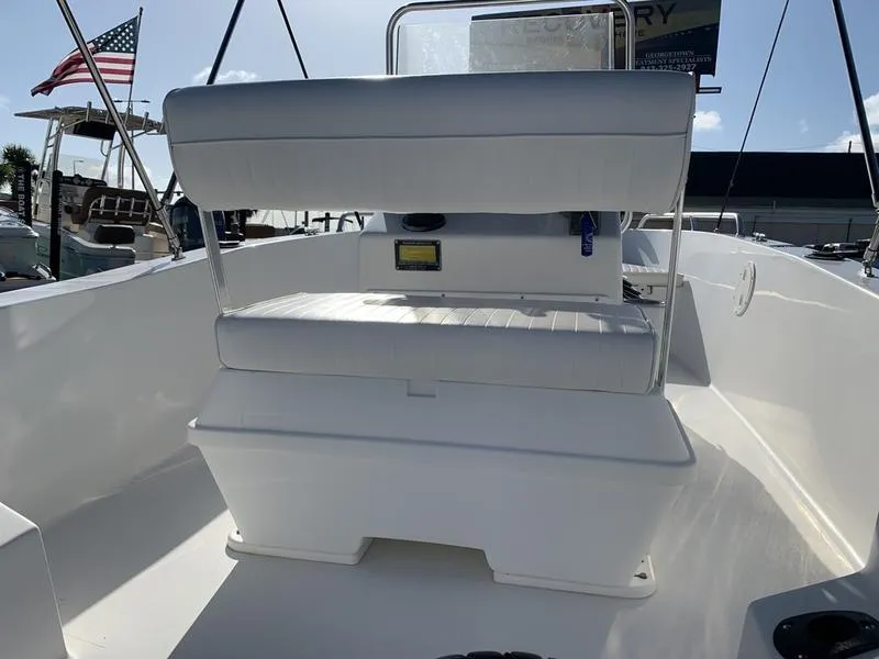 Slide: The Image of 2008 Sea King 180 CC boat interior with seating and console, docked under clear sky. - 11