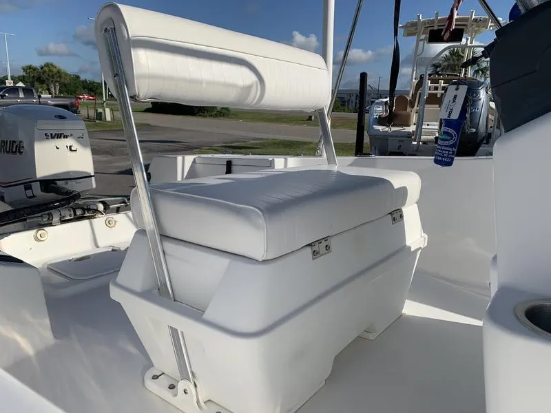Slide: The Image of 2008 Sea King 180 CC boat interior with white cushioned seating and Evinrude motor. - 12