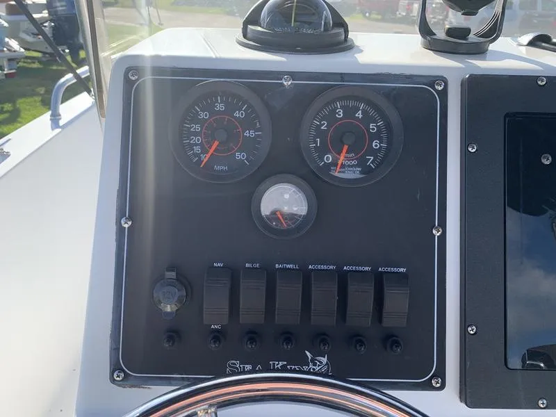 Slide: The Image of Control panel of a 2008 Sea King 180 CC boat with gauges and switches. - 15