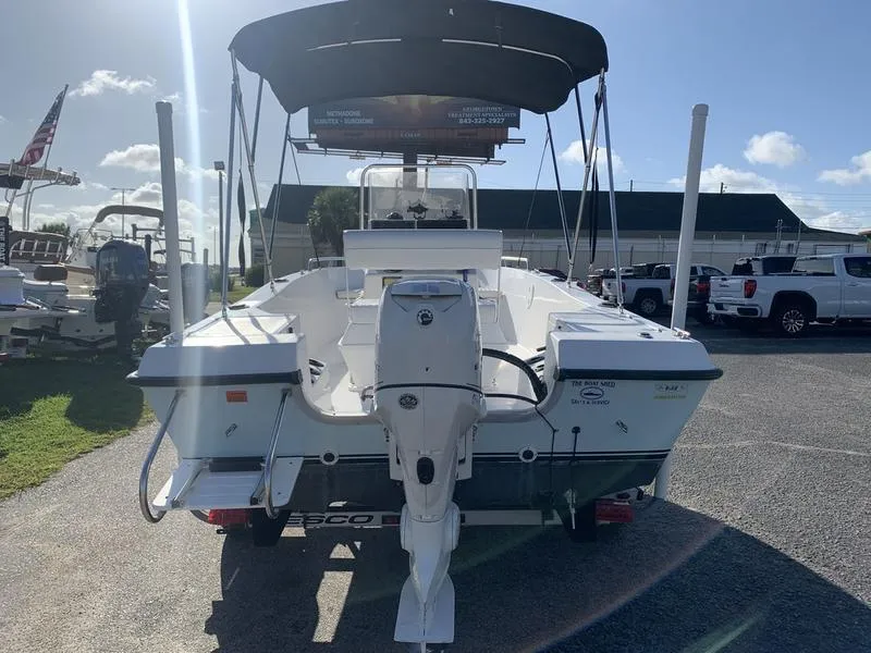 Slide: The Image of 2008 Sea King 180 CC boat with outboard motor and canopy, parked outdoors. - 3