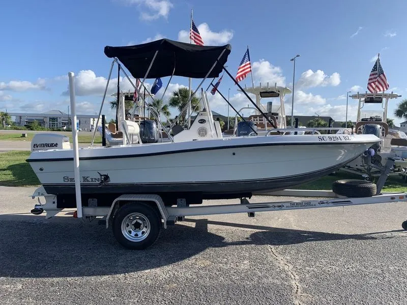 Slide: The Image of 2008 Sea King 180 CC boat on trailer, with Evinrude motor and American flags. - 5