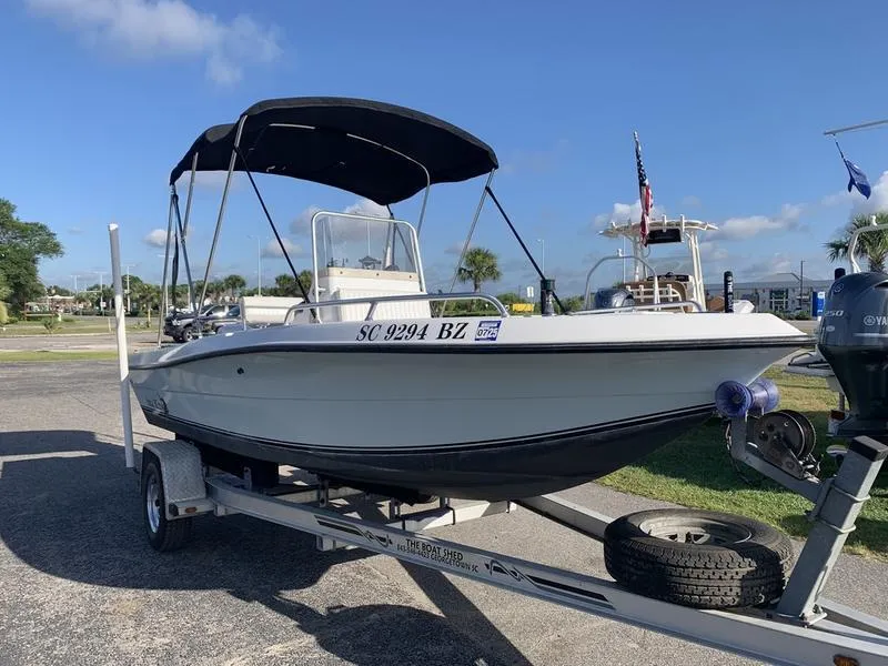 Slide: The Image of 2008 Sea King 180 CC boat on trailer with canopy, parked outdoors. - 6