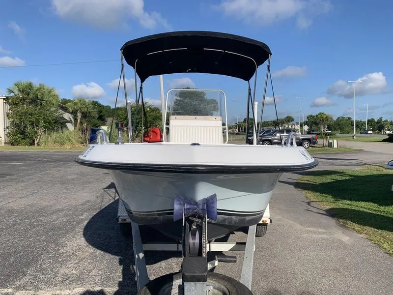 Slide: The Image of 2008 Sea King 180 CC boat on trailer, parked outdoors under a clear blue sky. - 7
