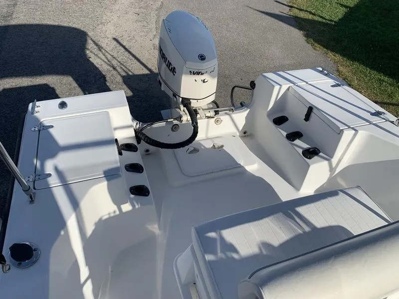 Slide: The Image of 2008 Sea King 180 CC boat interior with Evinrude outboard motor, white seating, and storage compartments. - 8