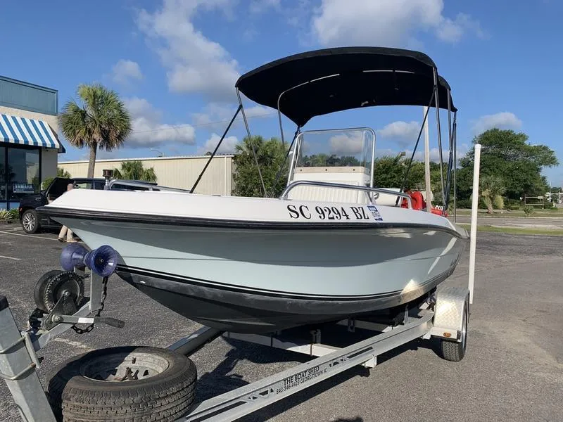 Slide: The Image of 2008 Sea King 180 CC boat on trailer, parked outdoors under blue sky. - 9