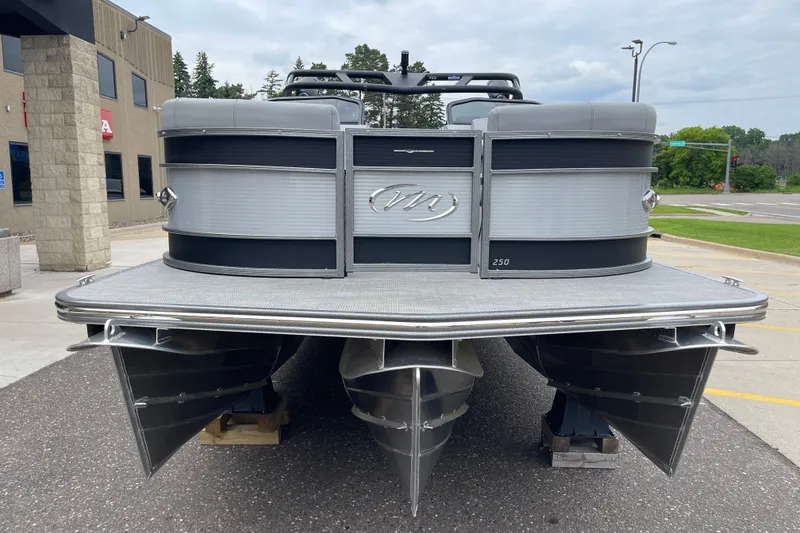 Slide: The Image of 2024 Manitou LX 25 RFXW pontoon boat, front view, parked outdoors. - 12