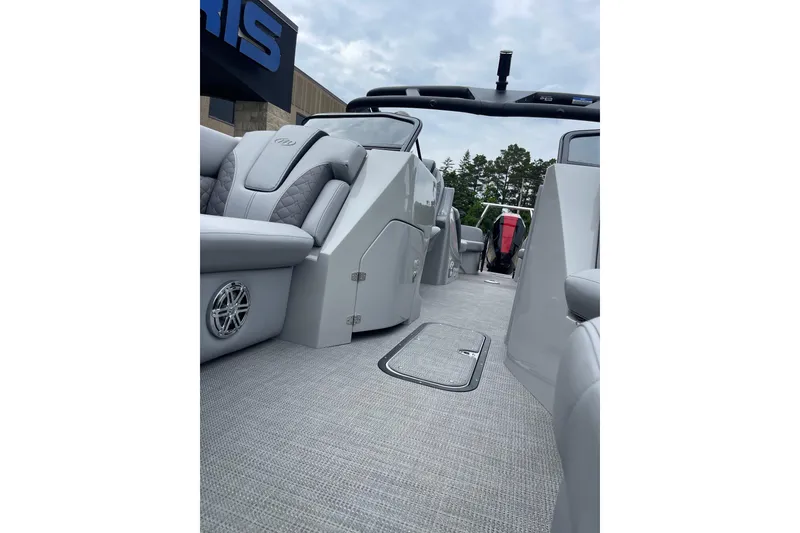 Slide: The Image of 2024 Manitou LX 25 RFXW pontoon boat interior with luxurious seating and modern design. - 17