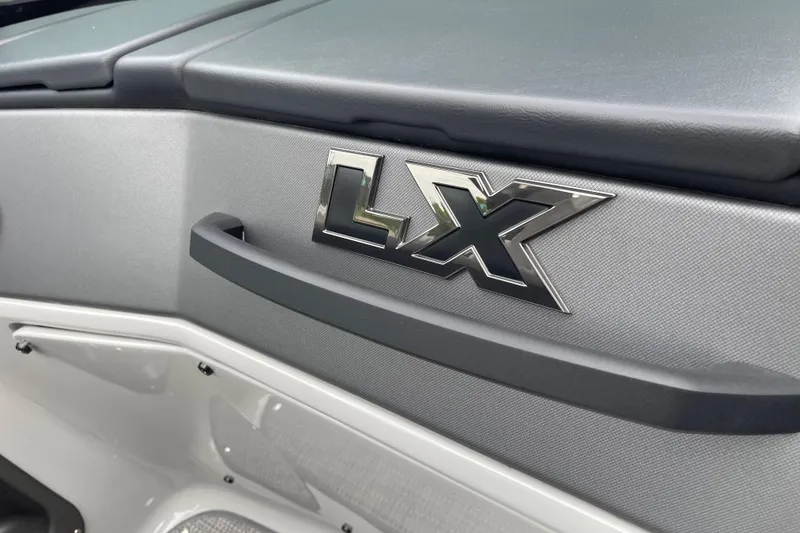 Slide: The Image of 2024 Manitou LX 25 RFXW boat interior with LX emblem detail. - 19