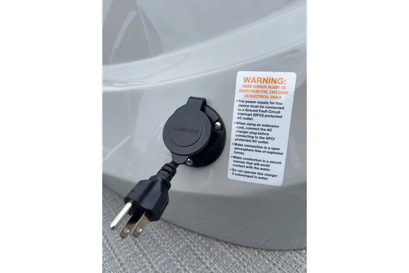 Slide: The Image of Charging port on 2024 Manitou LX 25 RFXW with safety warning label. - 20