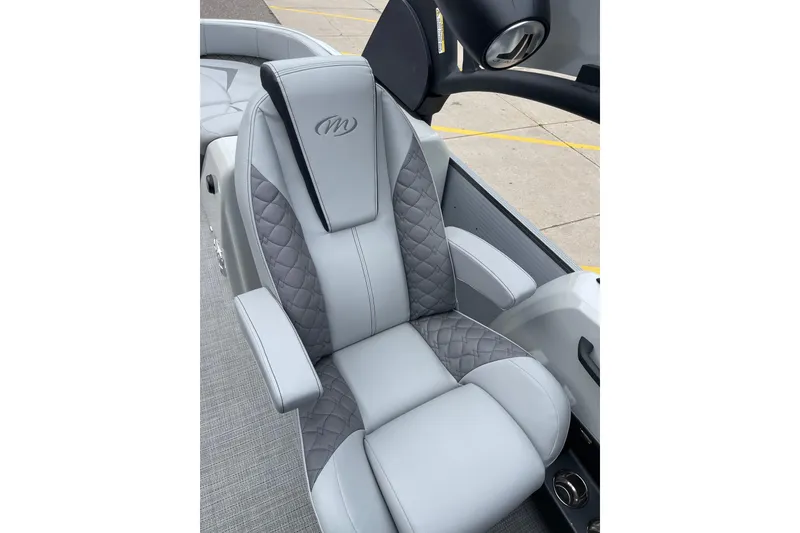 Slide: The Image of Luxurious seating in 2024 Manitou LX 25 RFXW boat, featuring quilted gray upholstery. - 21