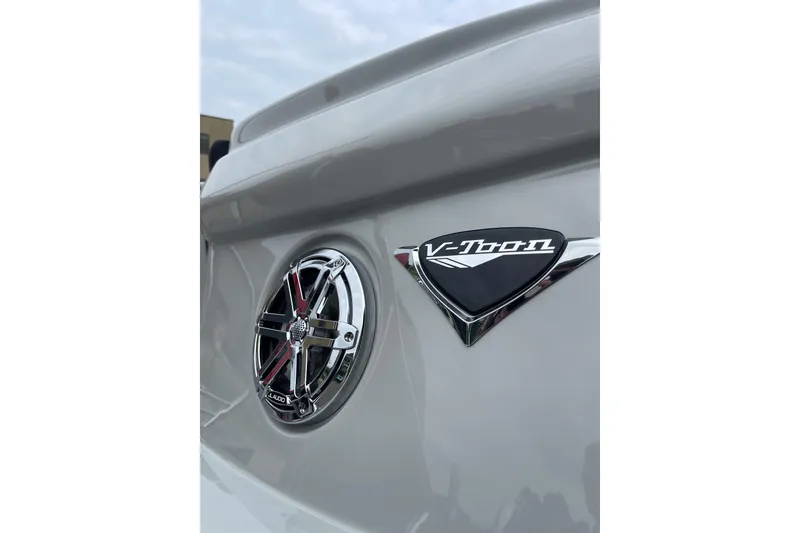 Slide: The Image of 2024 Manitou LX 25 RFXW boat with V-Toon logo and speaker detail. - 25