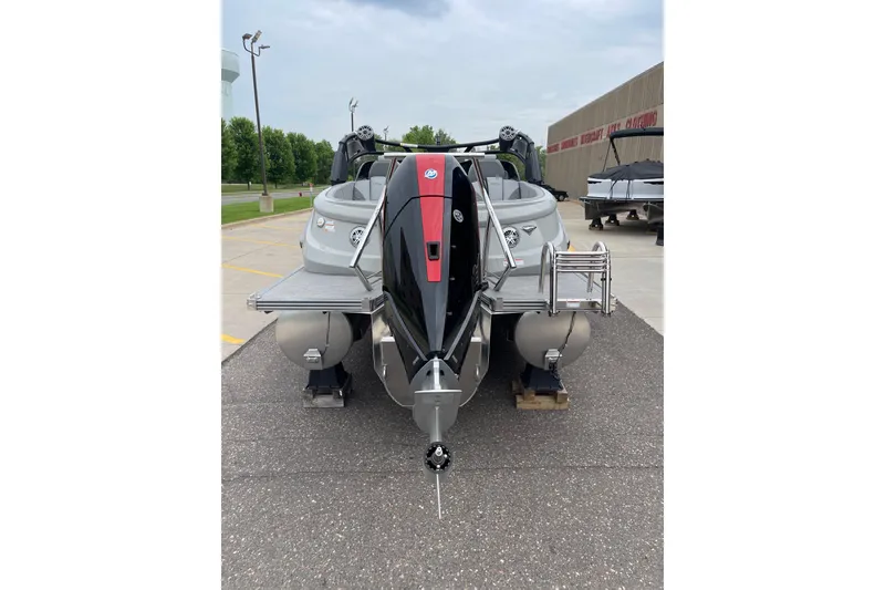 Slide: The Image of 2024 Manitou LX 25 RFXW pontoon boat displayed outdoors. - 5