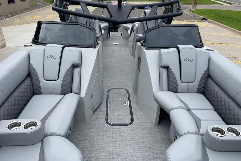Slide: The Image of 2024 Manitou LX 25 RFXW pontoon boat with luxurious gray seating and modern design. - 6