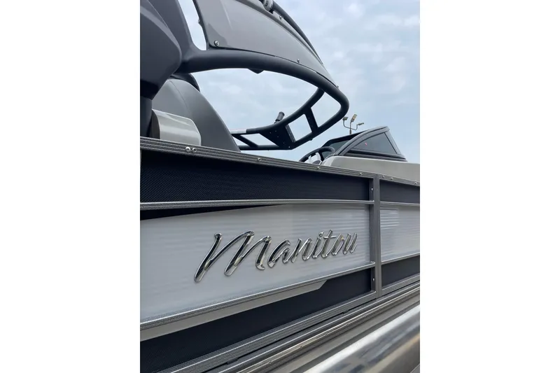 Slide: The Image of 2024 Manitou LX 25 RFXW pontoon boat with sleek design and branding. - 7