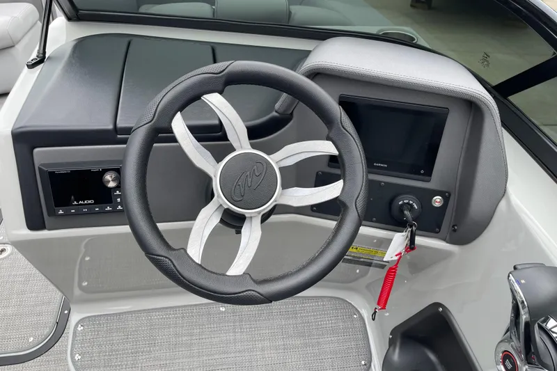 Slide: The Image of 2024 Manitou LX 25 RFXW boat dashboard with steering wheel and control panel. - 9