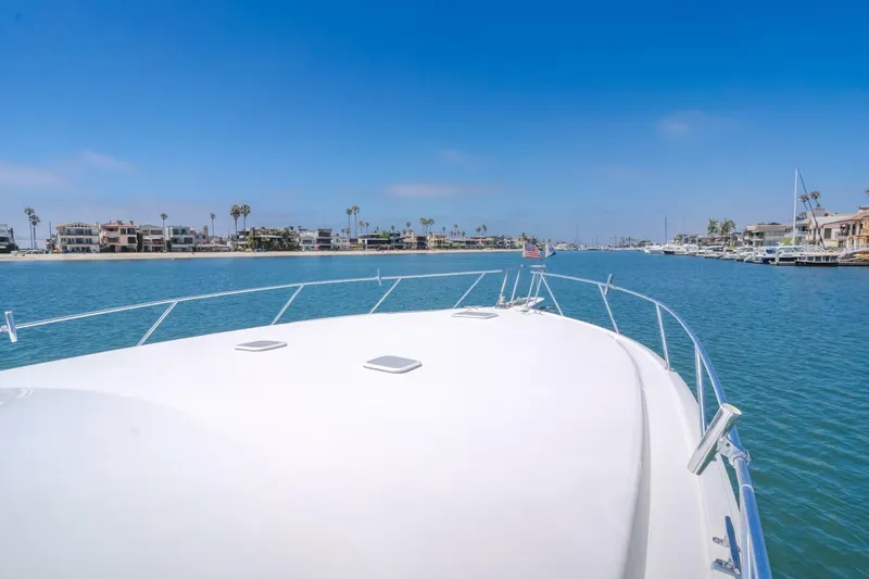 Slide: The Image of Bow view of 2008 Viking 52 Sport Coupe cruising in a scenic coastal area. - 27