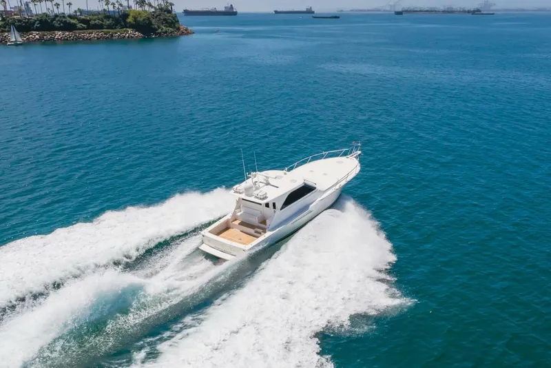 Slide: The Image of 2008 Viking 52 Sport Coupe cruising on open blue water. - 50