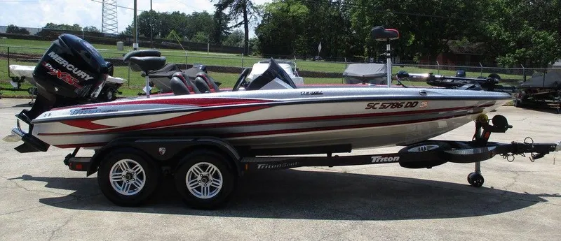 The Image of 2016 Triton 18 TrX bass boat with Mercury Pro XS engine on trailer. - 0