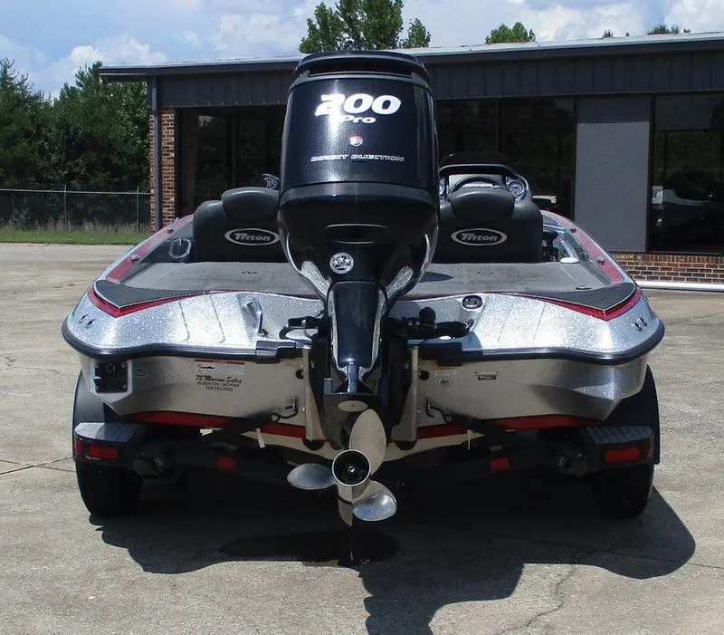 Slide: The Image of 2016 Triton 18 TrX boat with 200 Pro motor, parked outdoors. - 2