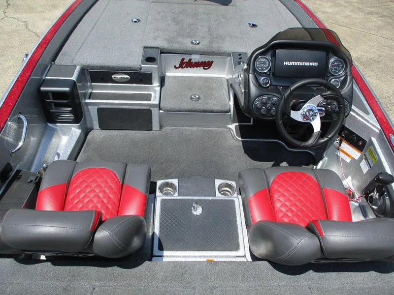 Slide: The Image of 2016 Triton 18 TrX boat interior with red and black seats, steering wheel, and Humminbird display. - 7